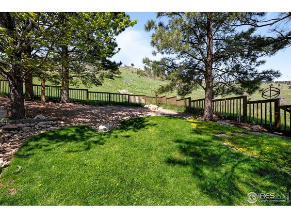 a view of a backyard with wooden fence