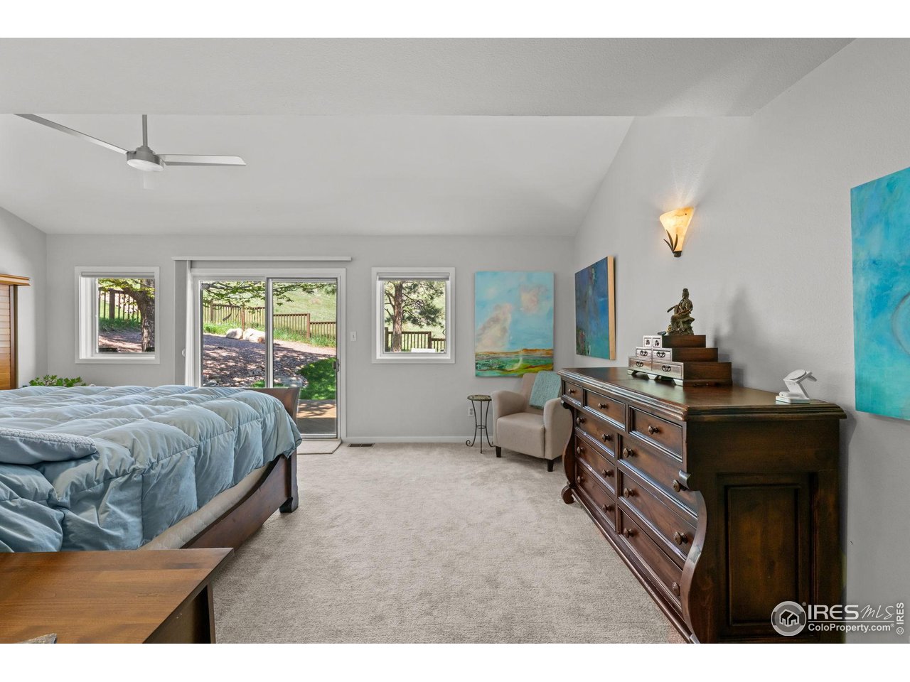3945 Promontory Court Boulder, CO 80304 - Photo 22 of 33 a bedroom with a bed and a chandelier