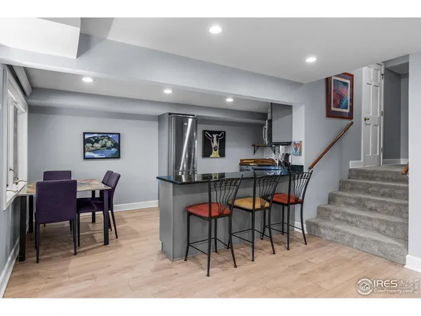 a dining room with furniture and wooden floor