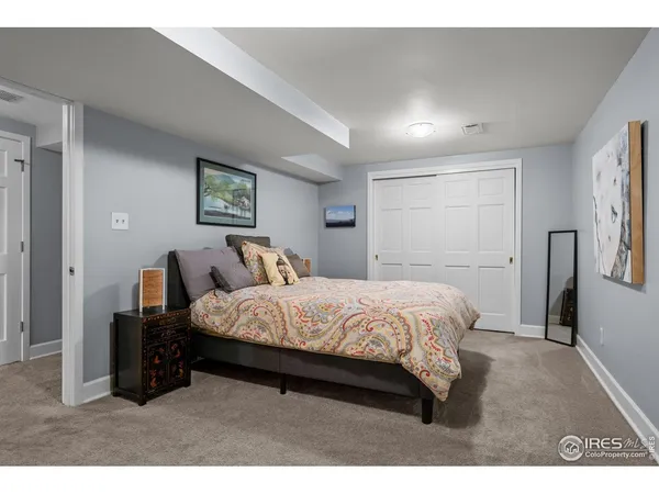 a bed room with a bed window and a night stand