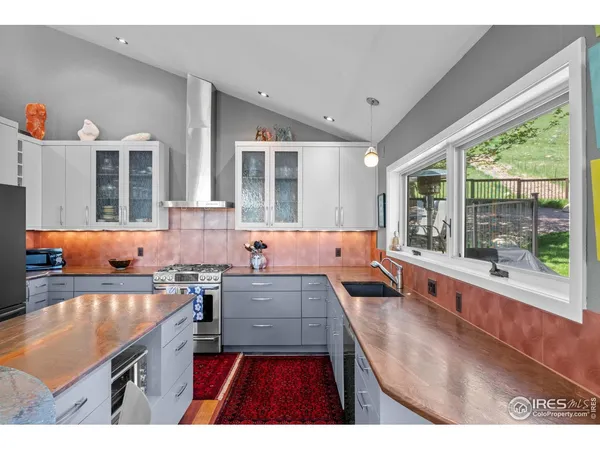 a open kitchen with granite countertop a sink stove and cabinets