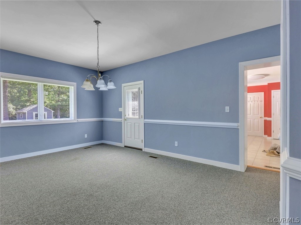 11311 Bundle Road Chesterfield, VA 23838 - Photo 10 of 38 an empty room with chandelier front door and windows