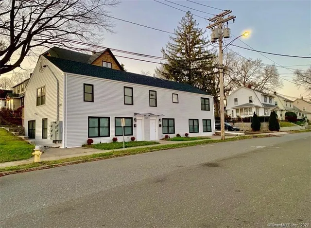 a front view of a house with a road