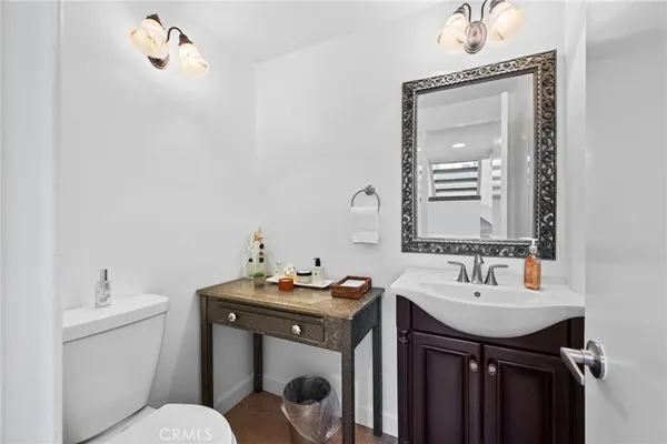 a bathroom with a sink vanity and a toilet