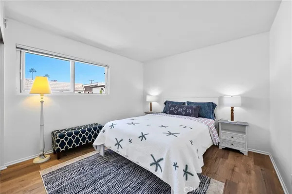 a bedroom with a bed lamp and a rug