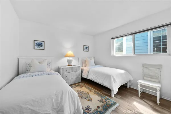 a bedroom with two beds and a window