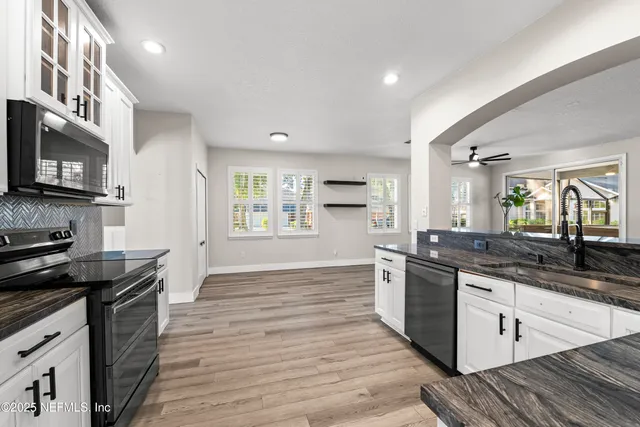 a view of empty room with wooden floor and window