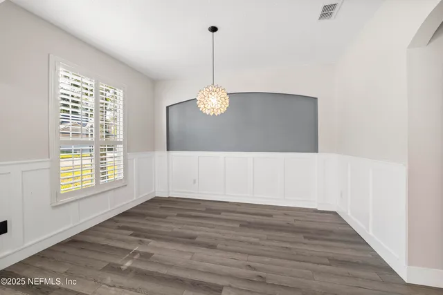 a view of front door and hallway with wooden floor