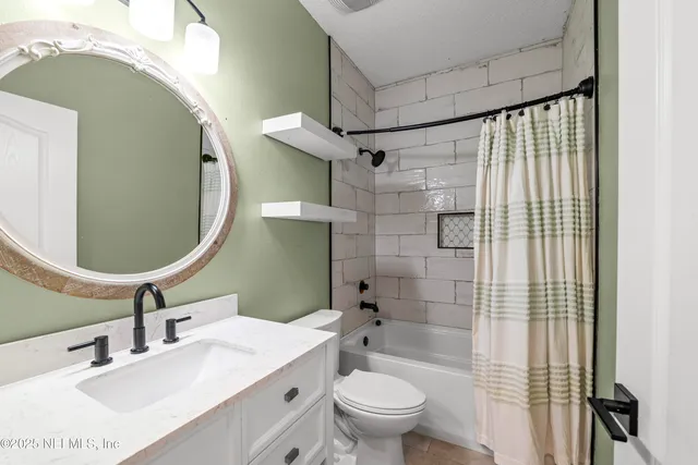 a view of a big house with a big yard and large trees