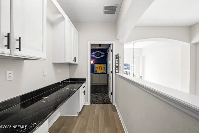 a view of a swimming pool with a garden and trees