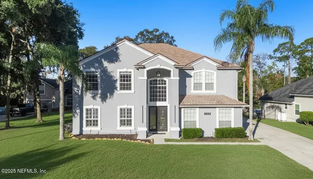 an aerial view of a house with a yard