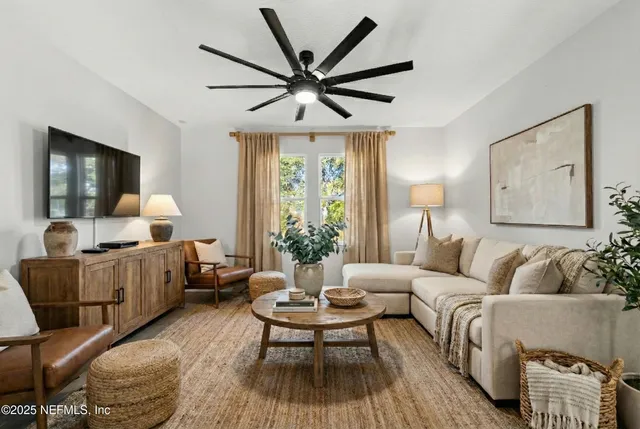 a living room with furniture and a large window