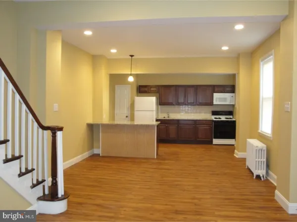 a kitchen with stainless steel appliances a refrigerator and a stove top oven