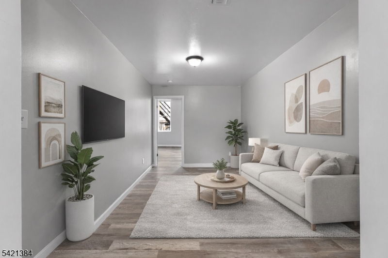 23 Monroe Street, Unit 2 Passaic, NJ 07055 - Photo 1 of 13 a living room with furniture and a potted plant