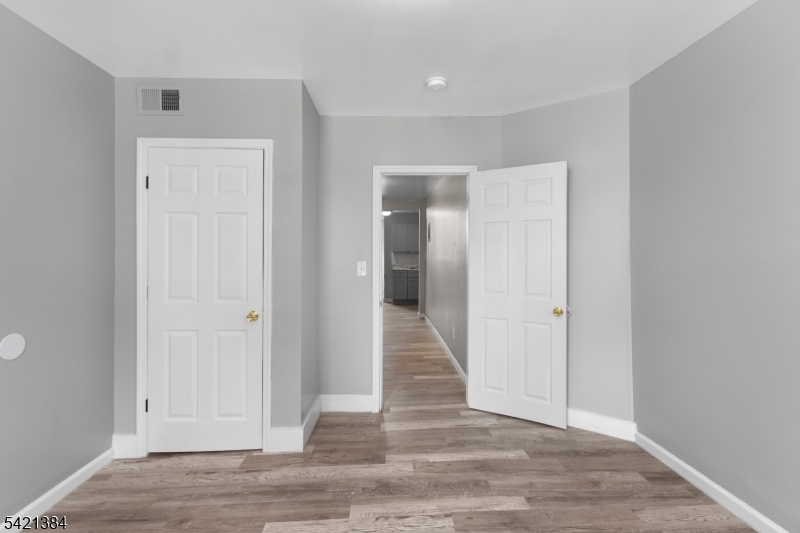 23 Monroe Street, Unit 2 Passaic, NJ 07055 - Photo 11 of 13 a view of a hallway with wooden floor