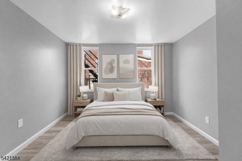 23 Monroe Street, Unit 2 Passaic, NJ 07055 - Photo 2 of 13 a bedroom with a bed and a window