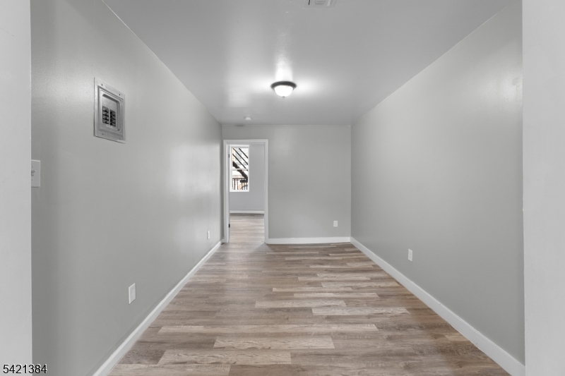 23 Monroe Street, Unit 2 Passaic, NJ 07055 - Photo 9 of 13 a view of an empty room and wooden floor