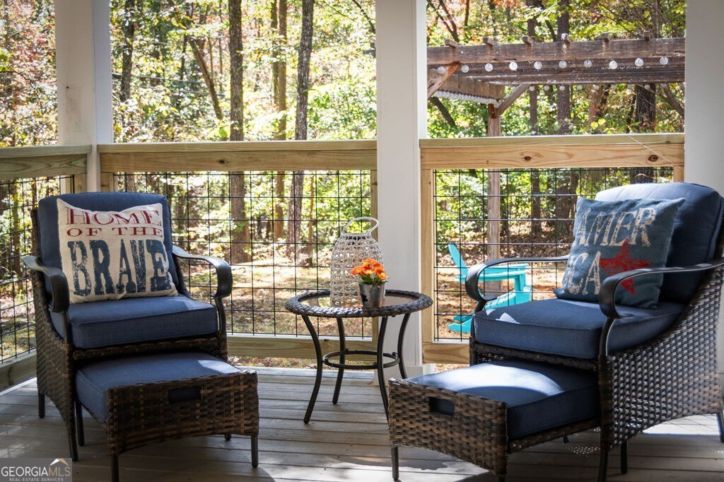 224 Timber Ridge Lane Ellijay, GA 30540 - Photo 14 of 61 a living room with furniture and a floor to ceiling window