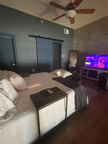 a bedroom with a bed and a chandelier