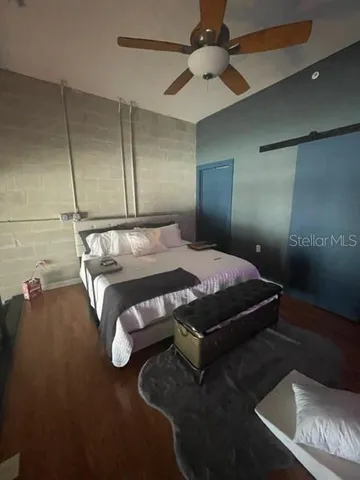 a bedroom with a bed and a chandelier