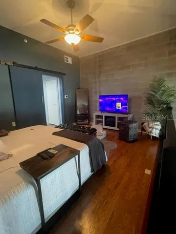 a bedroom with a bed and a chandelier