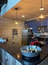 a kitchen with lots of counter top space cabinets and stainless steel appliances