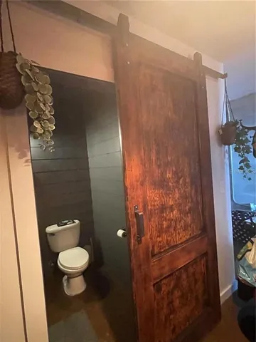 a bathroom with a toilet and a shower curtain