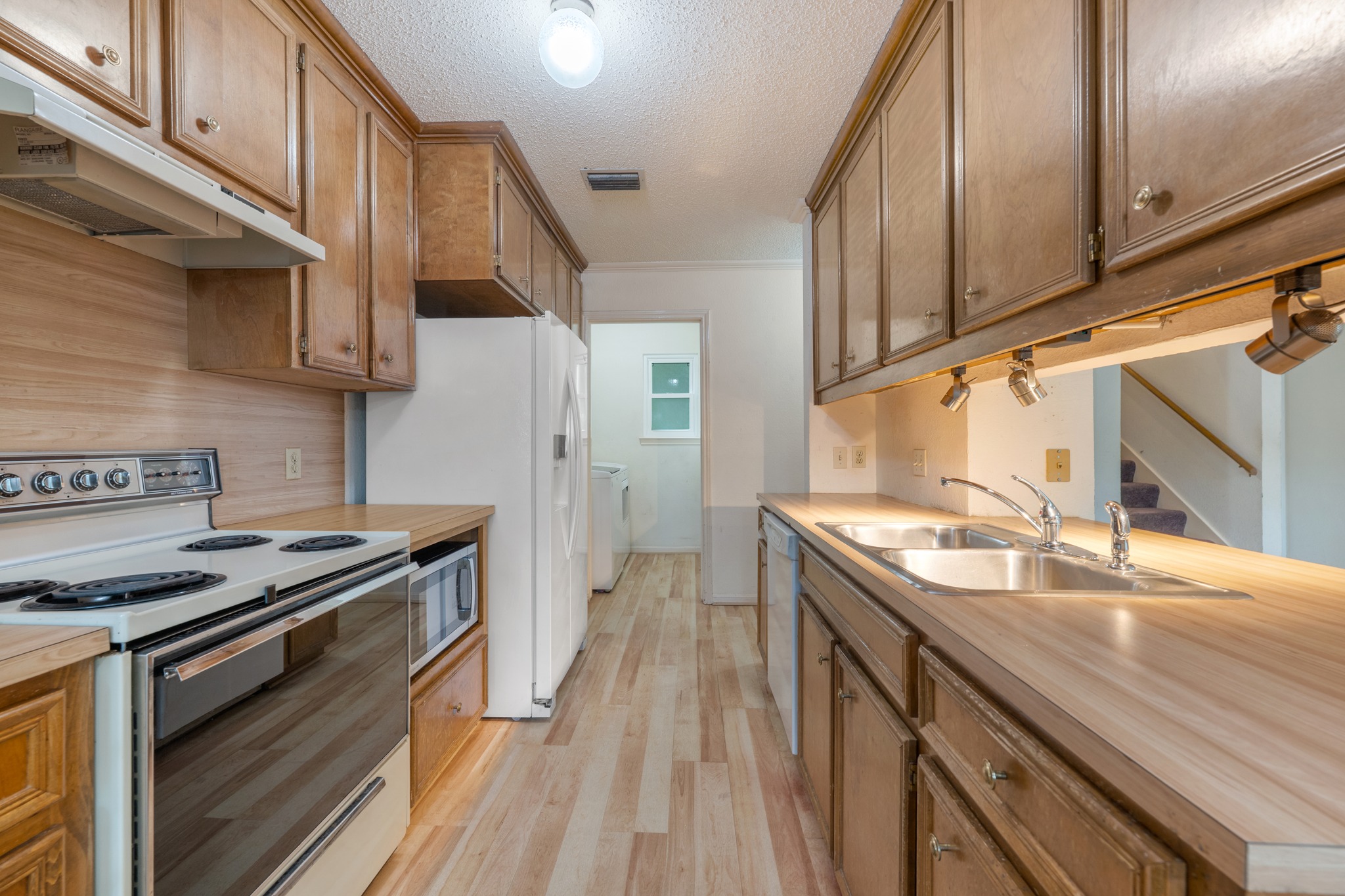 3845 Ranch Road 2222, Unit 19 Austin, TX 78731 - Photo 2 of 38 a kitchen with a sink stove top oven and cabinets