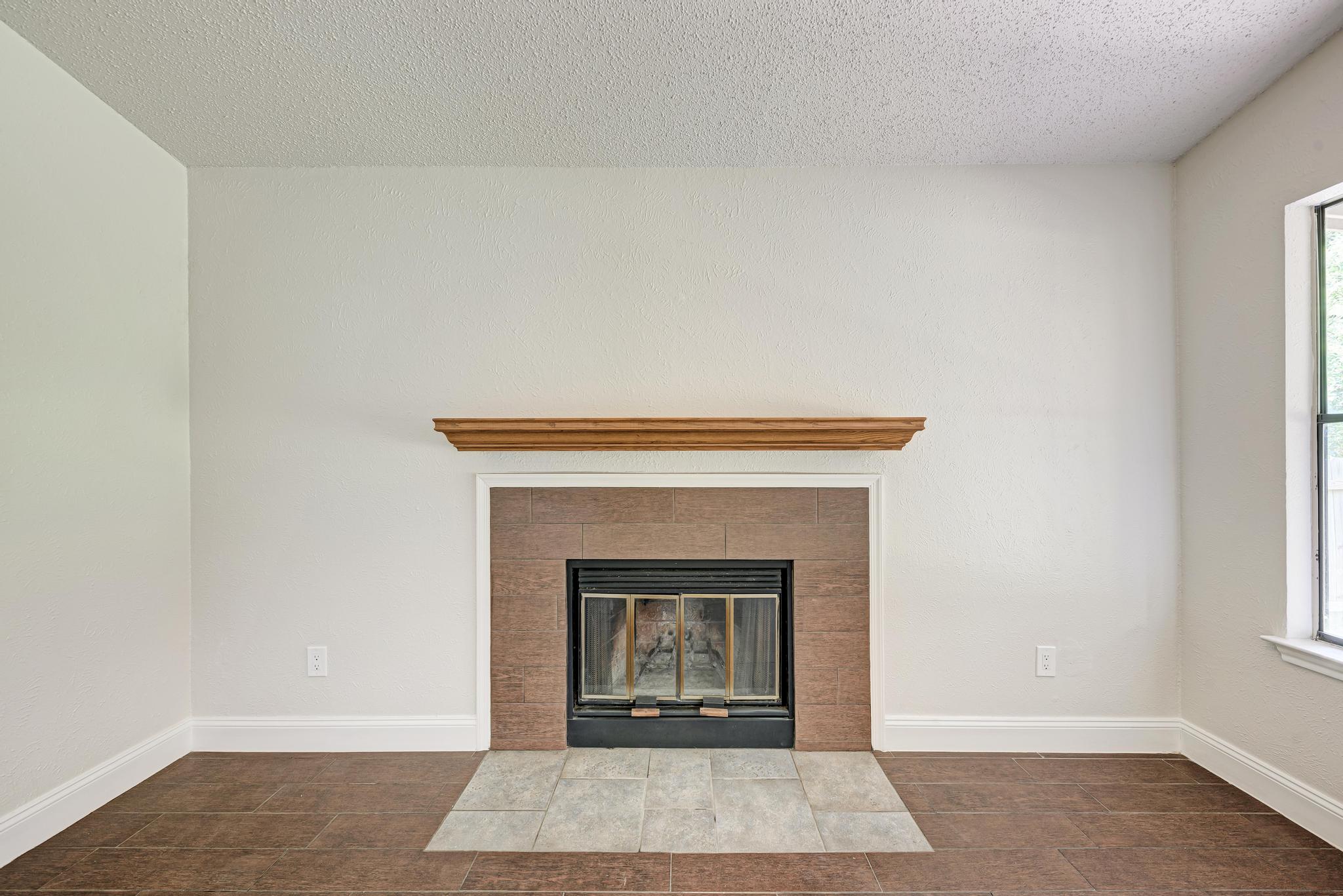 12108 Carnforth Drive Austin, TX 78753 - Photo 10 of 33 a white building with a fireplace
