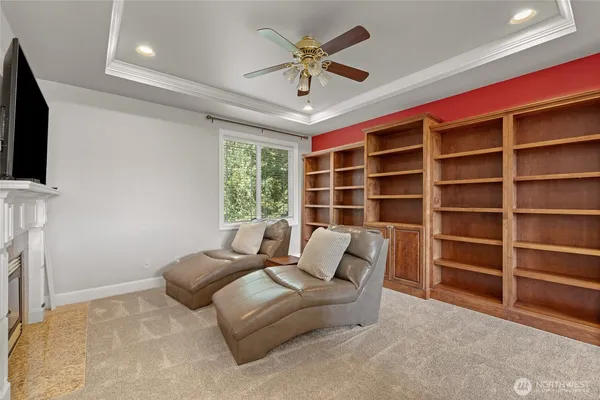 a living room with furniture a ceiling fan and a window