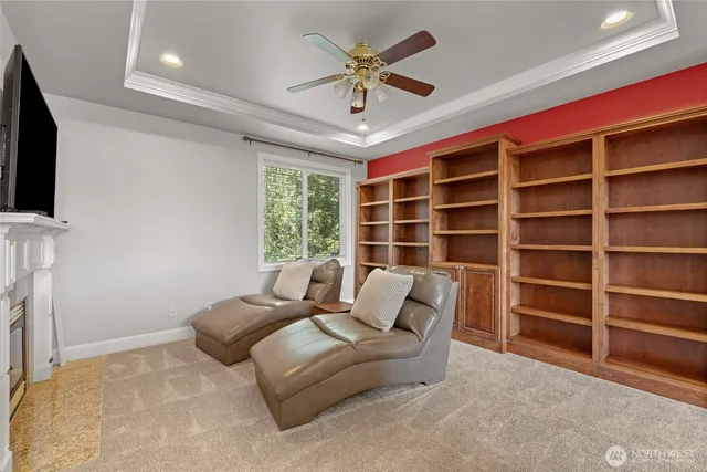 a living room with furniture a ceiling fan and a window
