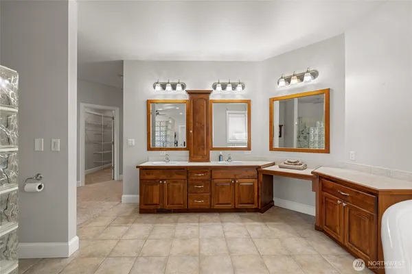 a spacious bathroom with a sink and a mirror
