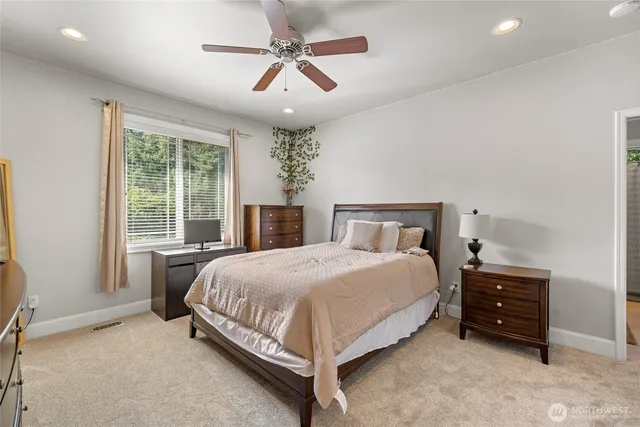 a bed room with a bed and a chair