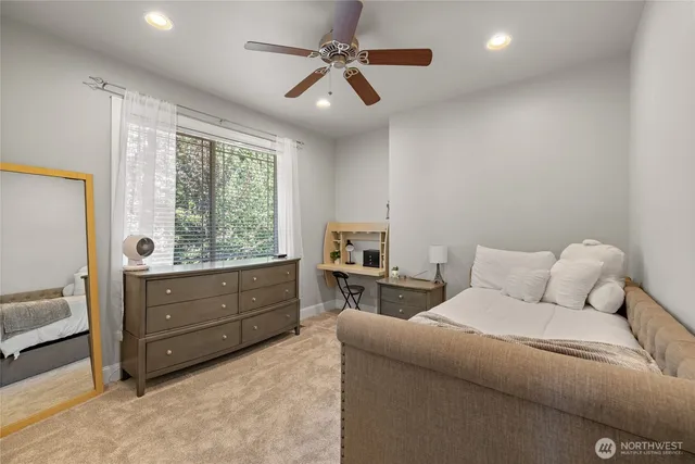 a bathroom with a sink a mirror a vanity and a shower