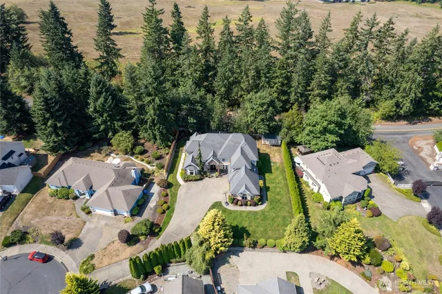 an aerial view of a house with yard swimming pool and mountains