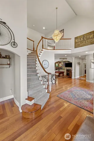 a view of a livingroom with furniture stairs and a chandelier