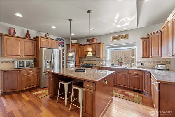 a kitchen with a sink stove and cabinets