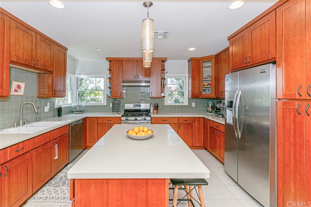 690 Arden Avenue Glendale, CA 91202 - Photo 29 of 70 a kitchen with a refrigerator a sink and a stove with wooden floor