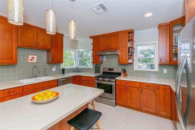 a living room with furniture fireplace and wooden floor