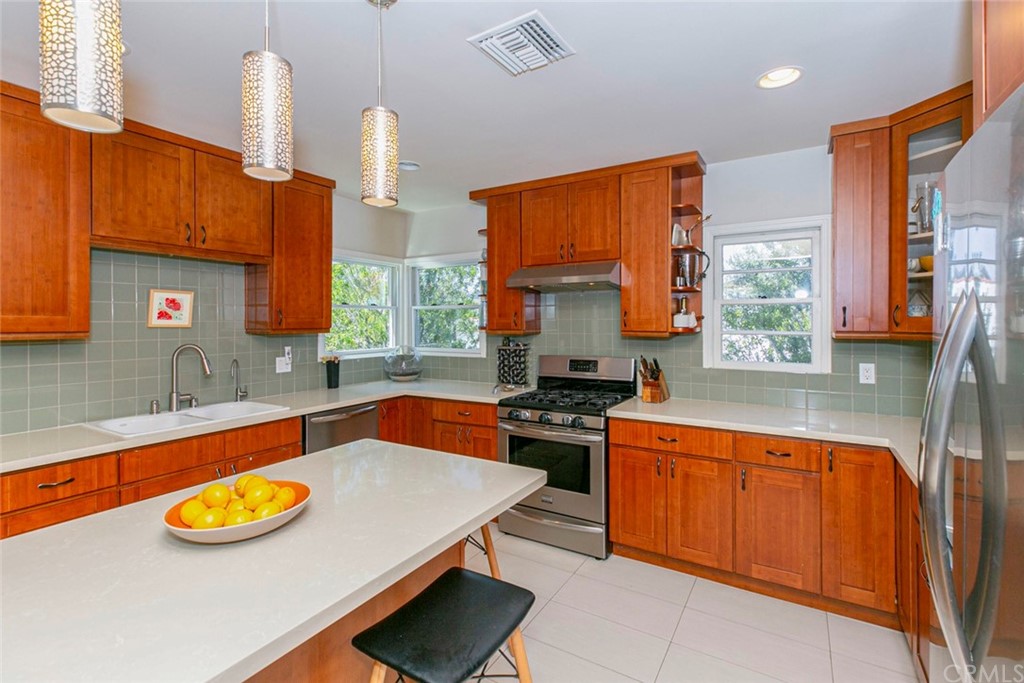 690 Arden Avenue Glendale, CA 91202 - Photo 30 of 70 a kitchen with stainless steel appliances granite countertop a sink a stove and a refrigerator