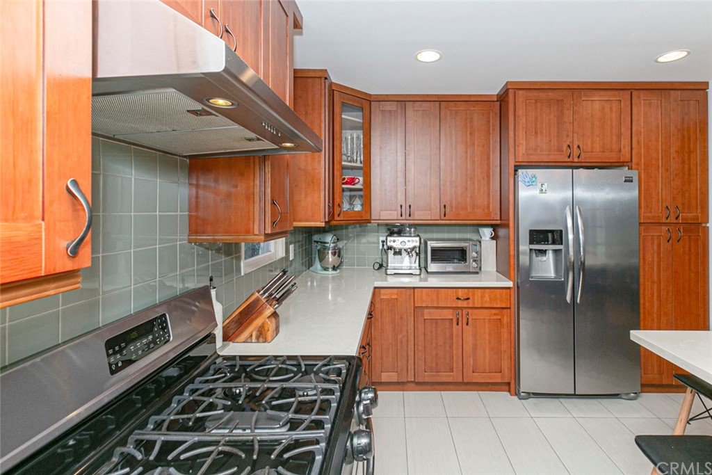 690 Arden Avenue Glendale, CA 91202 - Photo 31 of 70 a kitchen with stainless steel appliances granite countertop a stove top oven a sink and cabinets
