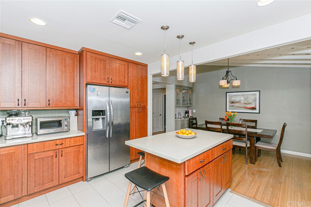 690 Arden Avenue Glendale, CA 91202 - Photo 32 of 70 a kitchen with stainless steel appliances a stove a refrigerator a sink dishwasher with a dining table and chairs