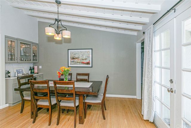 a bedroom with a bed a dresser and a large window