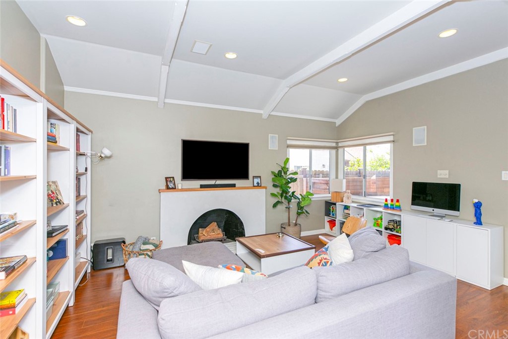 690 Arden Avenue Glendale, CA 91202 - Photo 42 of 70 a living room with furniture a flat screen tv and a fireplace