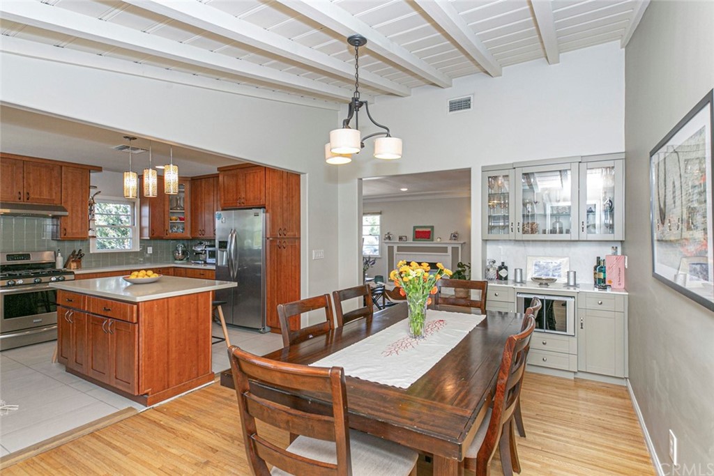 690 Arden Avenue Glendale, CA 91202 - Photo 46 of 70 a kitchen with stainless steel appliances granite countertop a stove top oven a refrigerator a sink dishwasher a dining table and chairs with wooden floor