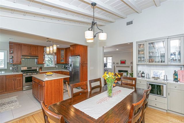 a view of a patio with couches table and chairs under an umbrella