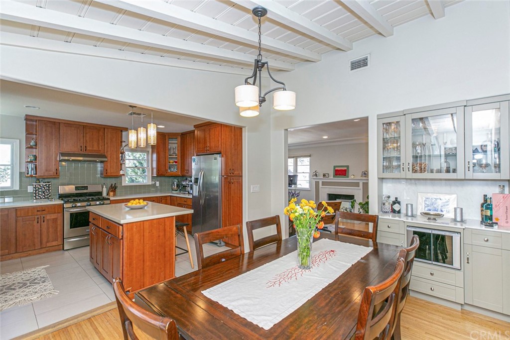 690 Arden Avenue Glendale, CA 91202 - Photo 47 of 70 a kitchen with stainless steel appliances granite countertop a stove top oven a dining table and chairs with wooden floor
