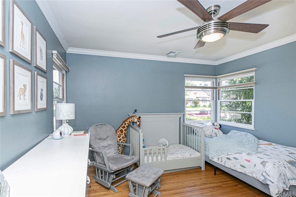 690 Arden Avenue Glendale, CA 91202 - Photo 49 of 70 a bedroom with a bed and wooden floor