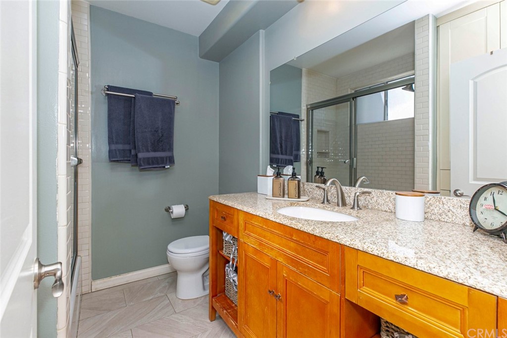 690 Arden Avenue Glendale, CA 91202 - Photo 58 of 70 a bathroom with a granite countertop sink a toilet and a mirror