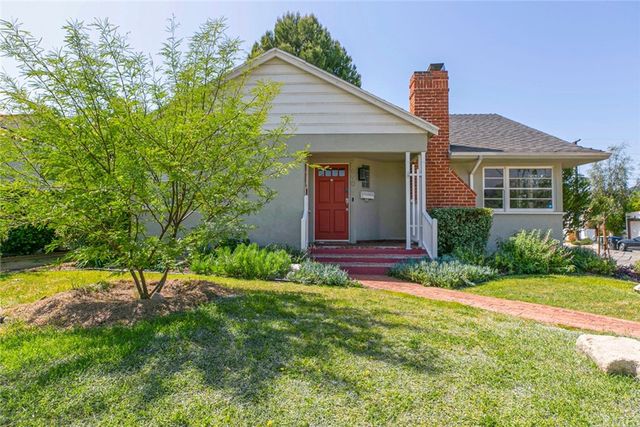a living room with furniture fireplace and a window
